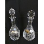 Two cut clear glass decanters with silver labels