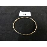 A 9ct gold bangle The polished bangle with grooved sides, weight approx. 5.2g.