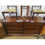 A contemporary hardwood sideboard with an arrangement of eight drawers raised upon bracket feet.