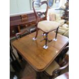 A Victorian mahogany extending dining table on lobed tapering legs, with two extra leaves