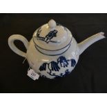 A 19th Century English blue and white teapot Decorated with stylised Oriental figures under a