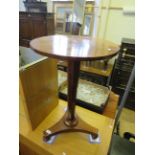 A mid 19th Century rosewood pedestal table, the circular top raised on a tapering octagonal shaft