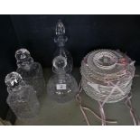 A collection of assorted ribbon plates and four various clear glass decanters.