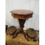 A Victorian walnut sewing table of octagonal tapering form and carved downswept supports.