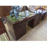A reproduction mahogany leather inset twin pedestal writing desk