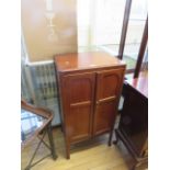 An early 20th Century mahogany sheet music cabinet with two panel doors