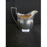 A George III silver cream jug with angled handle and ribbed decoration London hallmarked