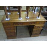 A reproduction yew wood leather inset twin pedestal writing desk