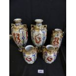 A group of five Noritake vases decorated with dragons on a gilt highlighted background