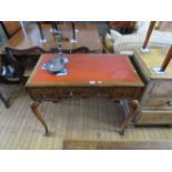 A good quality George I style walnut writing table with a leather inset writing surface above