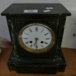 A black slate and marble mounted mantel clock