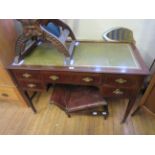 An Edwardian inlaid mahogany leather inset writing desk with an arrangement of five drawers