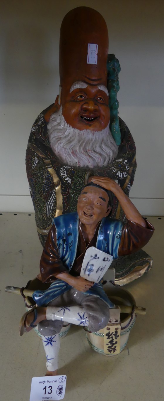 A Japanese satsuma figure of a wise man together with a further ceramic figure of a man seated on