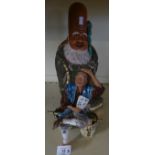 A Japanese satsuma figure of a wise man together with a further ceramic figure of a man seated on