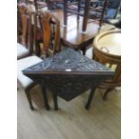 A Victorian carved oak folding triform table