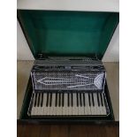 A vintage cased piano accordion marked Settimio Soprani