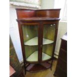 An Edwardian inlaid mahogany freestanding glazed corner display cabinet