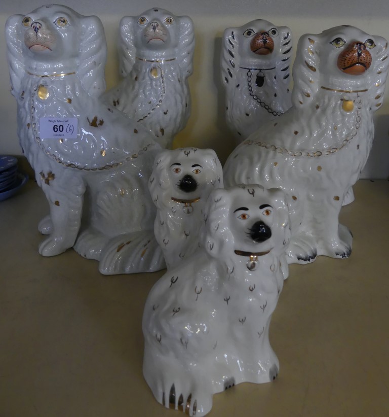 A collection of Staffordshire and Beswick model Spaniels, in a variety of designs