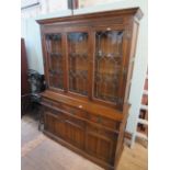 A mid 20th Century oak Priory style glazed bookcase, having three glazed doors above three drawers