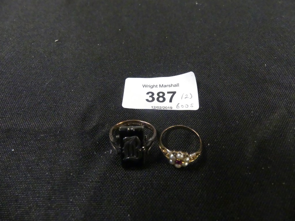 Two dress rings To include a 9ct gold onyx dress ring, together with a split pearl cluster ring,