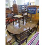 An 18th Century style oval oak drop leaf dining table, with six conforming ladderback rush seated