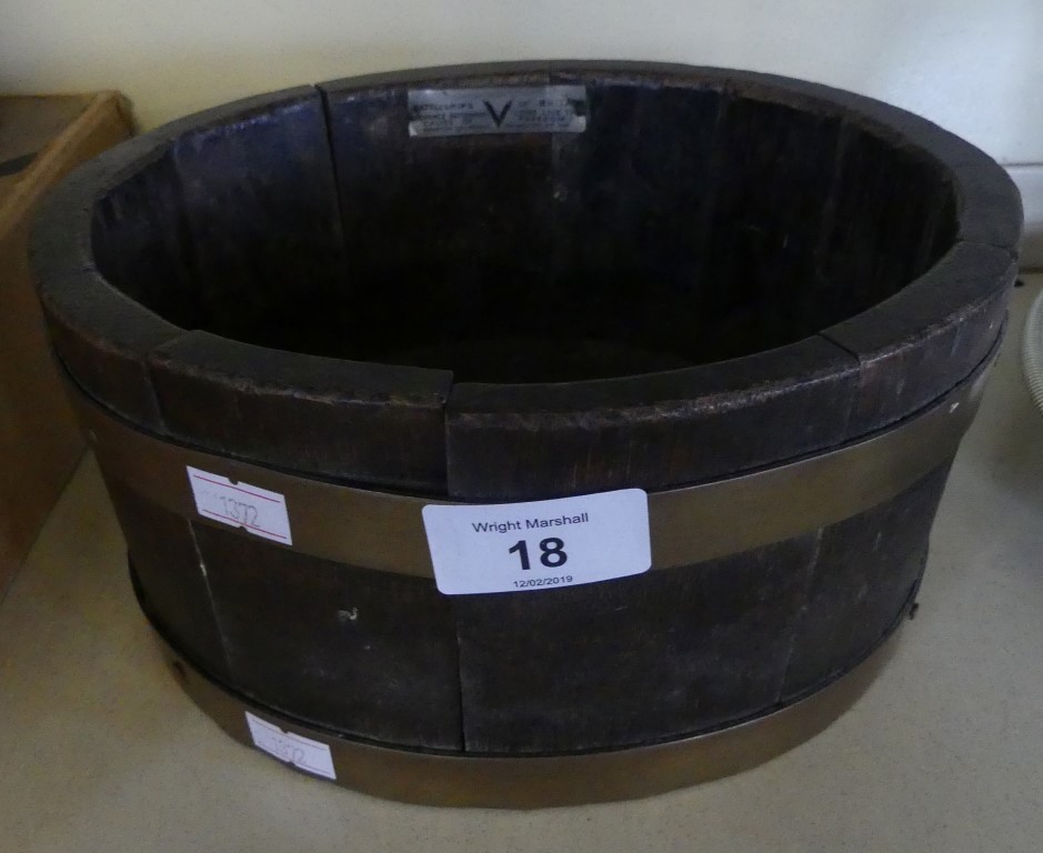 A small circular oak and brass bound shot bucket, bearing plaque 'Battleships of Britain' and marked