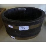 A small circular oak and brass bound shot bucket, bearing plaque 'Battleships of Britain' and marked