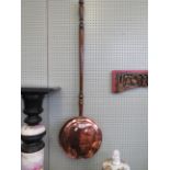 A 19th Century copper warming pan