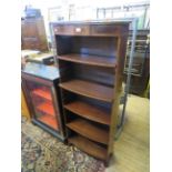 A reproduction mahogany bowfront open bookcase, with four adjustable shelves