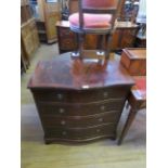 A reproduction serpentine mahogany chest of four long drawers