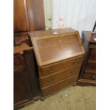 An early 20th Century Waring & Gillow oak bureau, the fall front enclosing fitted interior above