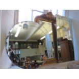 A modern circular bevelled wall mirror and a second similar rectangular example (2)