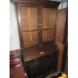 An early 20th Century dark stained oak bureau bookcase cabinet with glazed top section