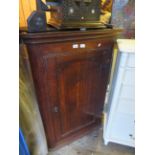 A Georgian oak single door wall mounted oak corner cupboard