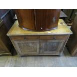 A Victorian pine washstand with two drawers above two cupboard doors