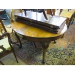 A Continental style walnut extending dining table, the oval extending top with four extra leaves,