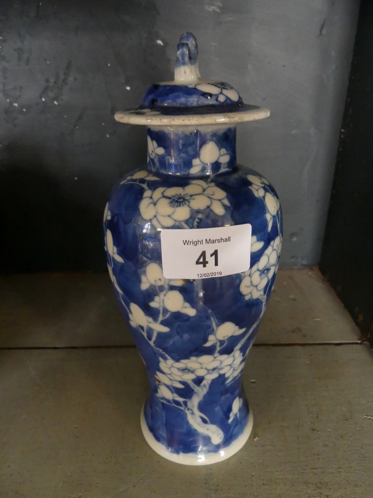 A Chinese blue and white Prunus pattern covered baluster vase, four character mark to base.