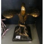 A gilt metal model of a crane wrestling a snake, raised on a plinth base (af)