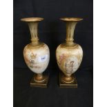 A pair of Doulton Burslem baluster vases decorated with panels of young ladies raised on plinth