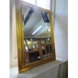 A giltwood framed rectangular bevelled wall mirror