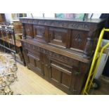 An 18th Century and later oak court cupboard The top section with two small panelled doors and