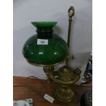 An usual brass former oil lamp formed as an Aladdin's lantern, fitted with a green vesta glass shade