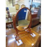 A Georgian style oval mahogany dressing table mirror