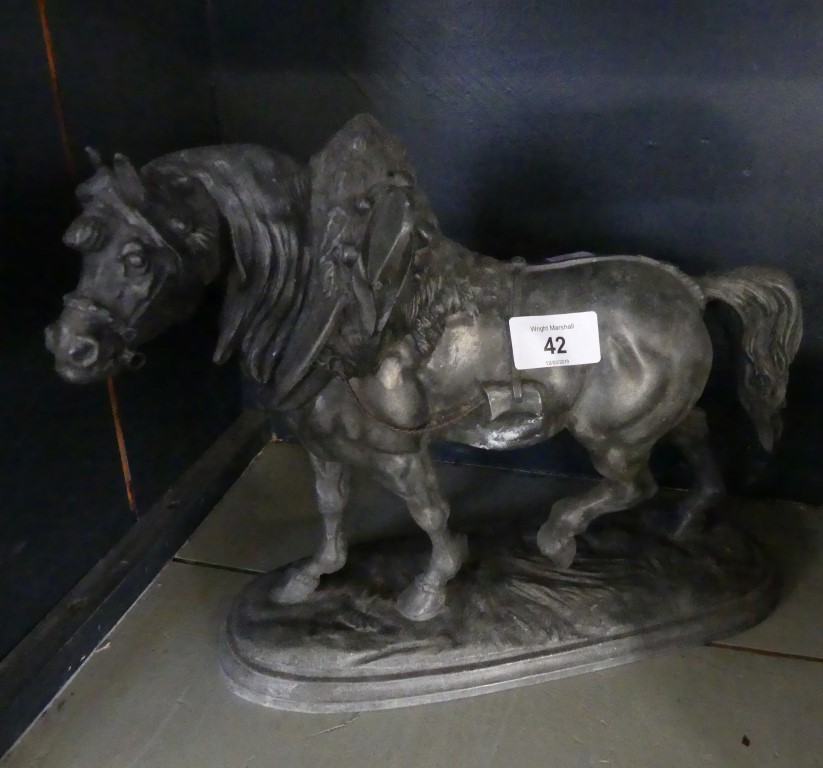 A Spelter model of a horse in harness, raised on oval plinth base