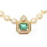 An emerald diamond and cultured pearl necklace The rectangular shaped emerald within a brilliant cut