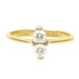 An 18ct gold diamond dress ring Designed as a brilliant cut diamond duo, with tapered shoulders,