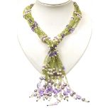 A multi-gem necklace The multi-strand peridot, cultured pearl and amethyst necklet with white