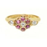 An Edwardian 18ct gold ruby and diamond cluster ring The old cut diamond and circular shaped ruby