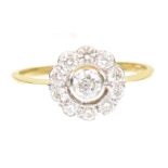 A diamond cluster ring Of floral design, the brilliant cut diamond collet within a similarly cut