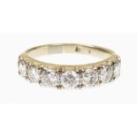 A diamond seven stone ring Designed as a brilliant cut diamond line with tapered shoulders,